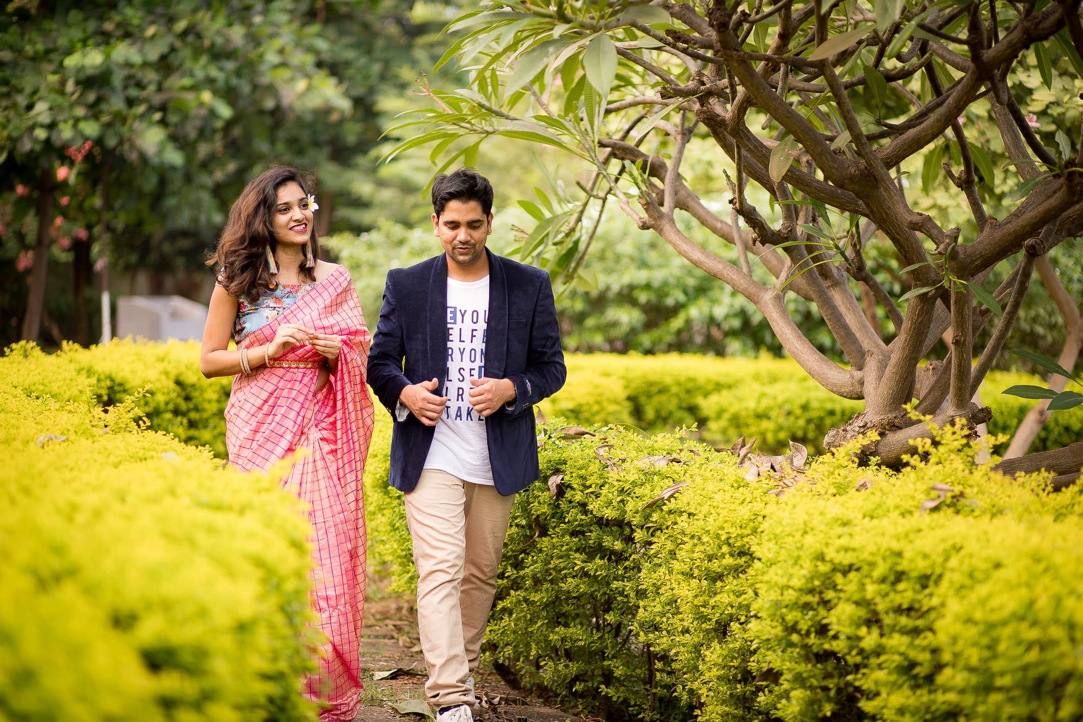 Romantic couple walking through yellow-foliaged garden